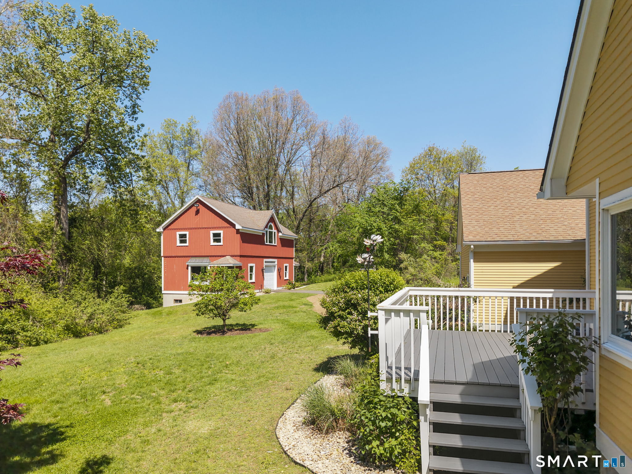555 Waterville Road Avon, CT 06001 - Photo 5 of 40 a front view of a house with a yard