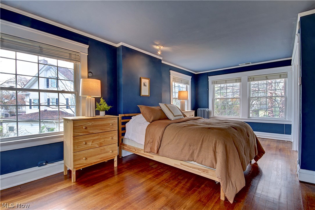 3054 Somerton Road Cleveland, OH 44118 - Photo 25 of 40 Bedroom featuring ornamental molding, radiator, and dark hardwood / wood-style floors
