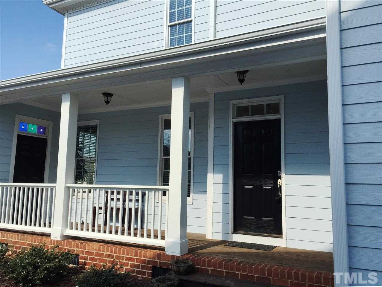 1307 Ileagnes Road Raleigh, NC 27603 - Photo 2 of 24 Tucked behind the street facing front door, this inviting porch overlooks the side yard. It's a great place to enjoy a morning cup of coffee.