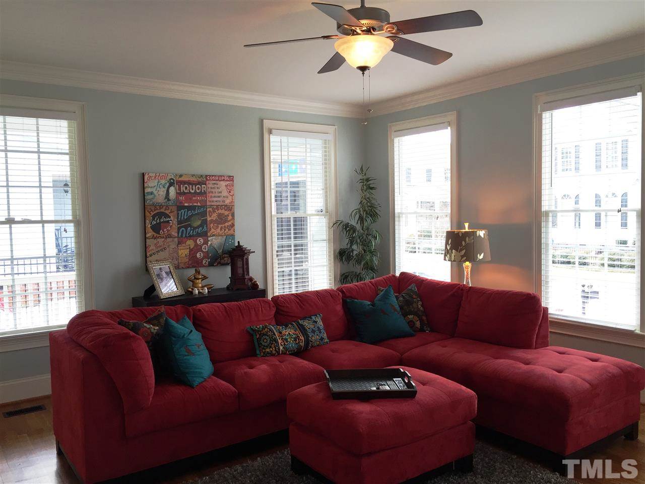 1307 Ileagnes Road Raleigh, NC 27603 - Photo 6 of 24 Light filled family room has five large windows, hardwood floors and a ceiling fan.