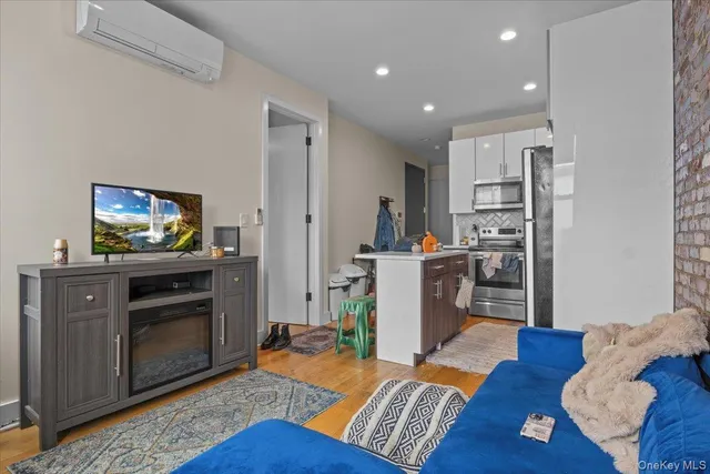 a kitchen with stainless steel appliances granite countertop a refrigerator a stove a sink a microwave and cabinets