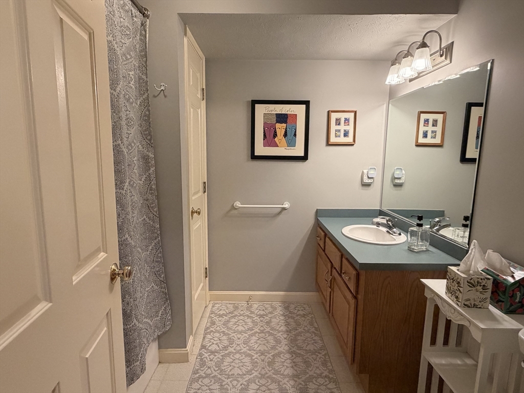 7 Conant Road, Unit 21 Winchester, MA 01890 - Photo 19 of 27 a bathroom with a sink toilet and vanity