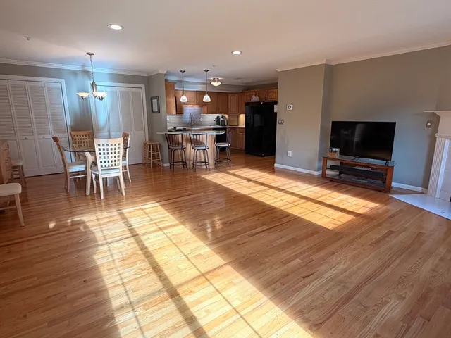 a lobby with furniture and a flat screen tv