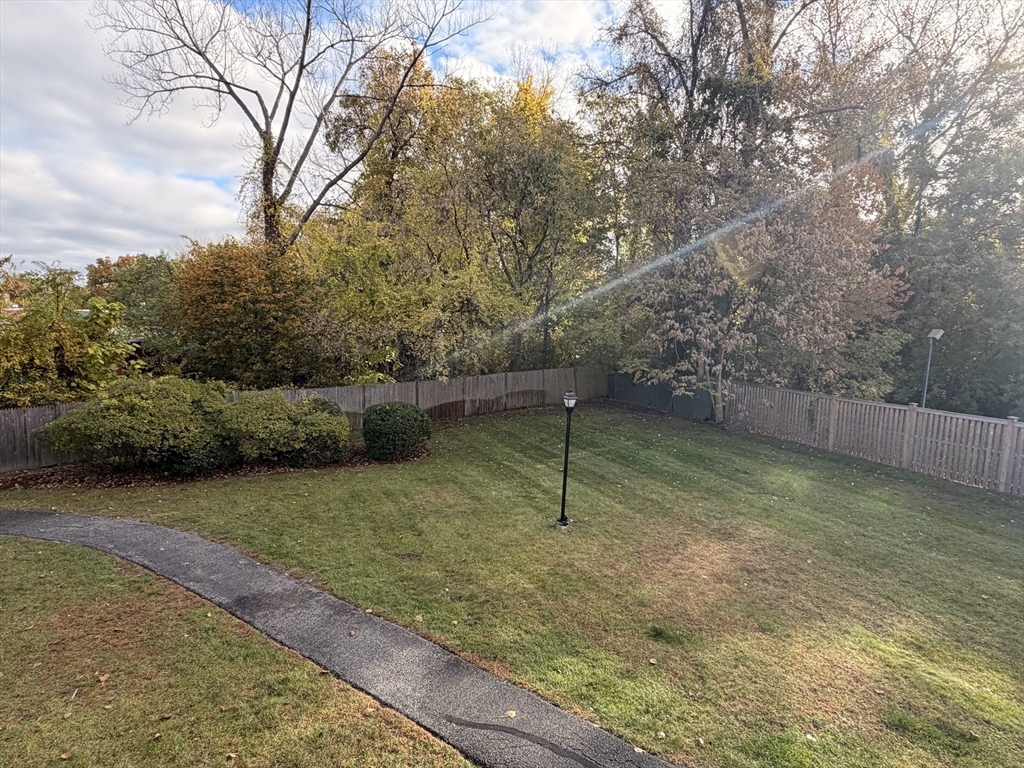 7 Conant Road, Unit 21 Winchester, MA 01890 - Photo 24 of 27 a backyard of a house with lots of green space