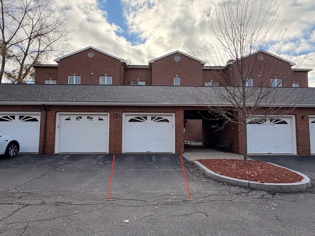 a view of a house with a car parked in front of it