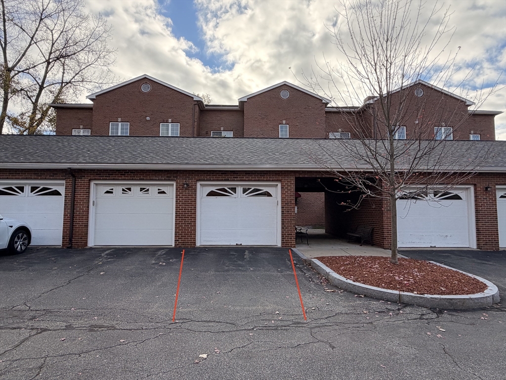 7 Conant Road, Unit 21 Winchester, MA 01890 - Photo 26 of 27 a view of a house with a car parked in front of it