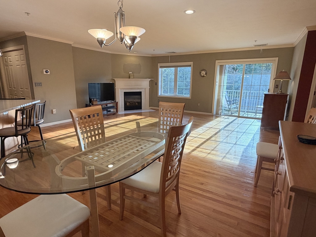 7 Conant Road, Unit 21 Winchester, MA 01890 - Photo 4 of 27 a view of a dining room with furniture window and wooden floor