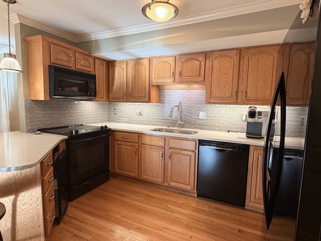 7 Conant Road, Unit 21 Winchester, MA 01890 - Photo 6 of 27 a kitchen with a sink stove and microwave