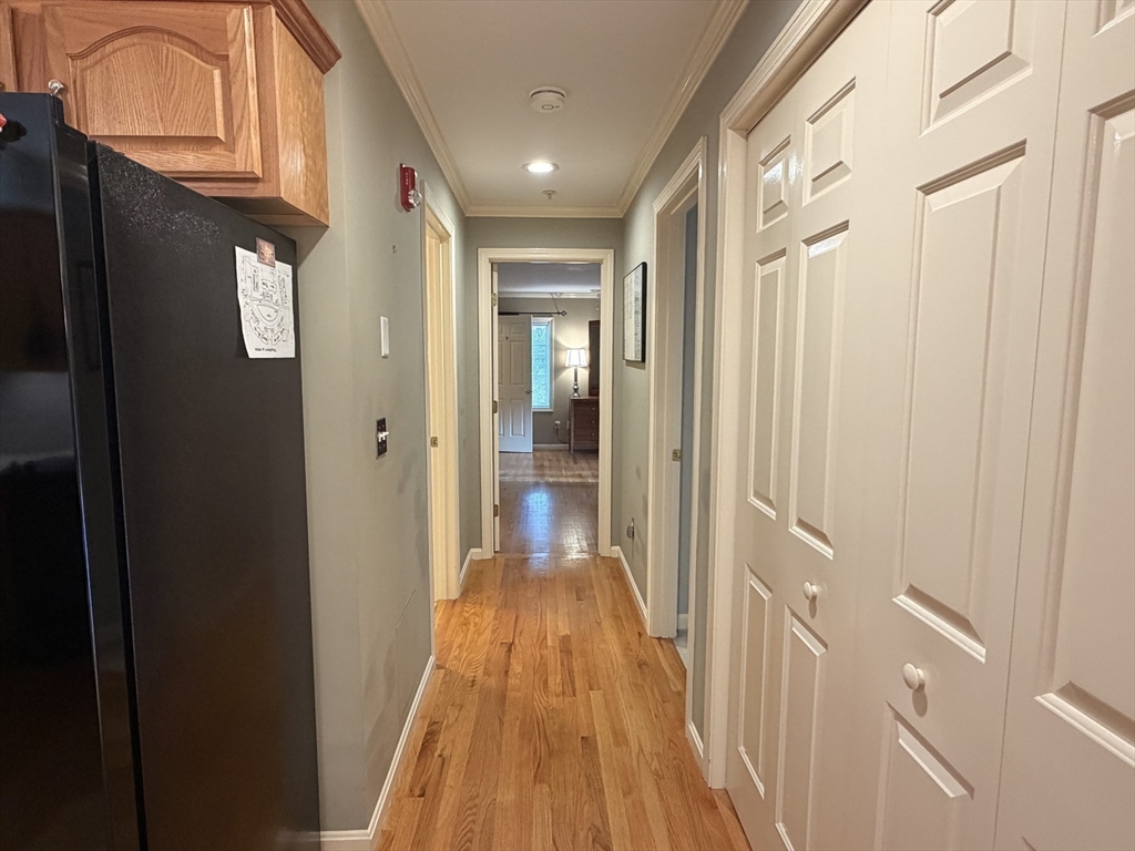 7 Conant Road, Unit 21 Winchester, MA 01890 - Photo 10 of 27 a view of a hallway with wooden floor and staircase