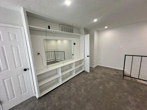 a bedroom with a bed and a view of bathroom