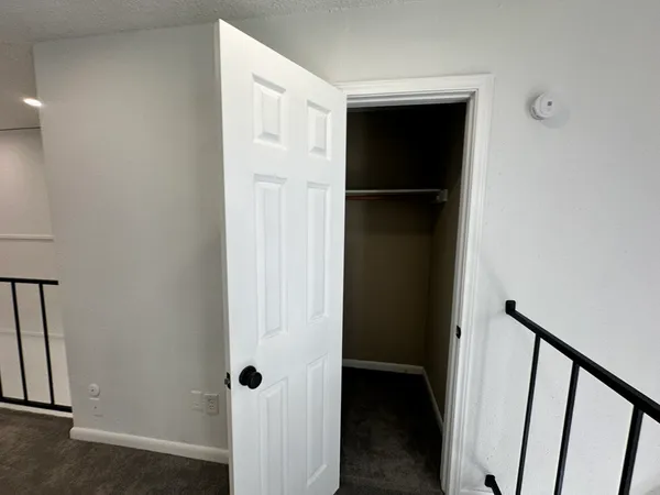 a view of walk in closet with empty racks