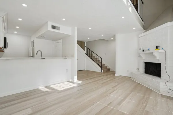 a view of a kitchen with a sink and a fireplace
