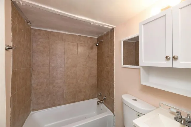a bathroom with a toilet and a bathtub