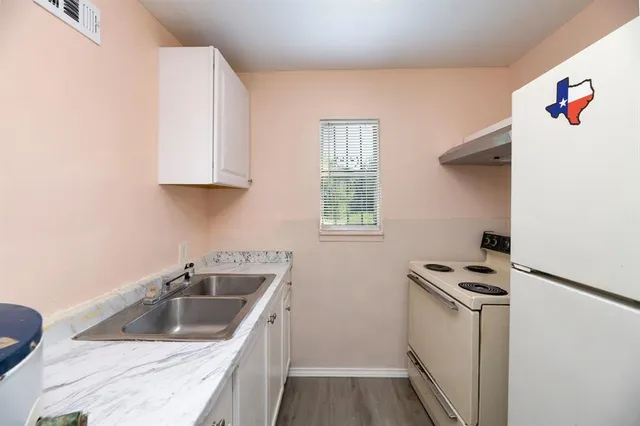 a kitchen with sink and cabinets