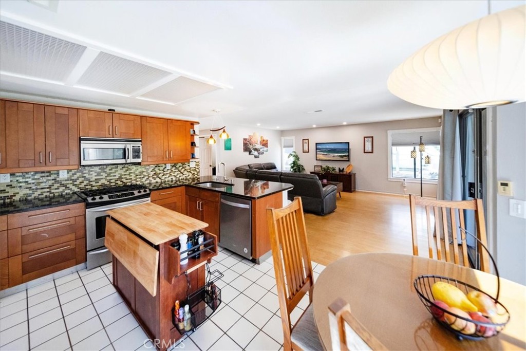 5963 Rio Valle Drive Bonsall, CA 92003 - Photo 16 of 49 a kitchen with stainless steel appliances granite countertop a sink and a refrigerator