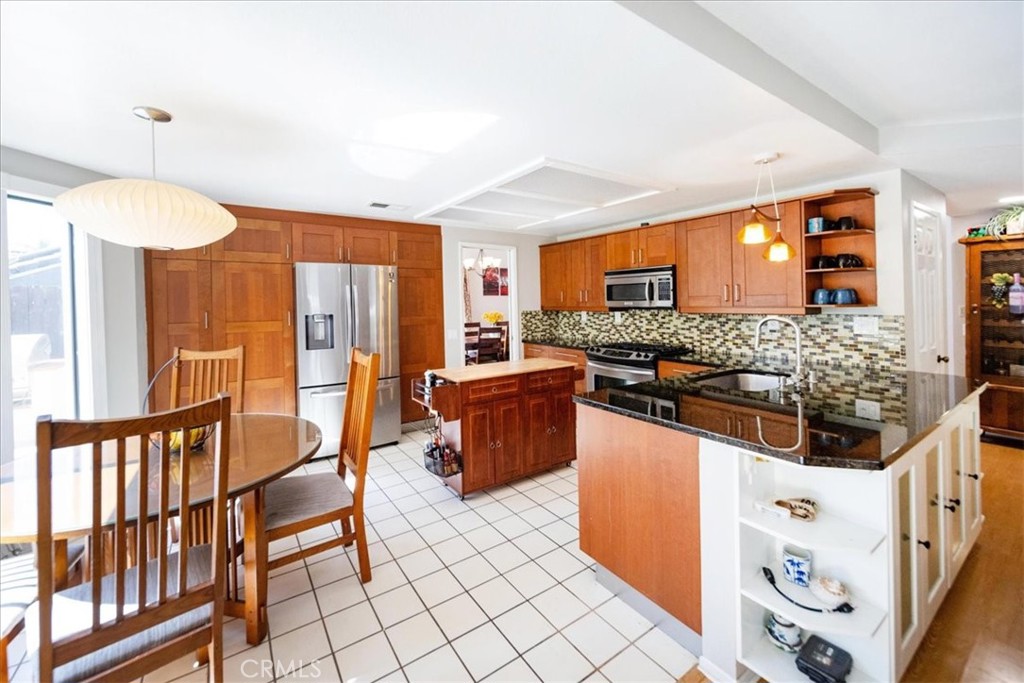 5963 Rio Valle Drive Bonsall, CA 92003 - Photo 17 of 49 a kitchen with stainless steel appliances a stove a sink and a refrigerator
