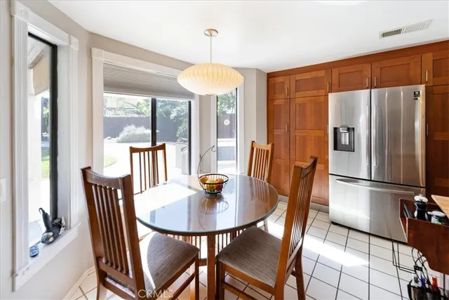 a dining room with furniture a chandelier and window