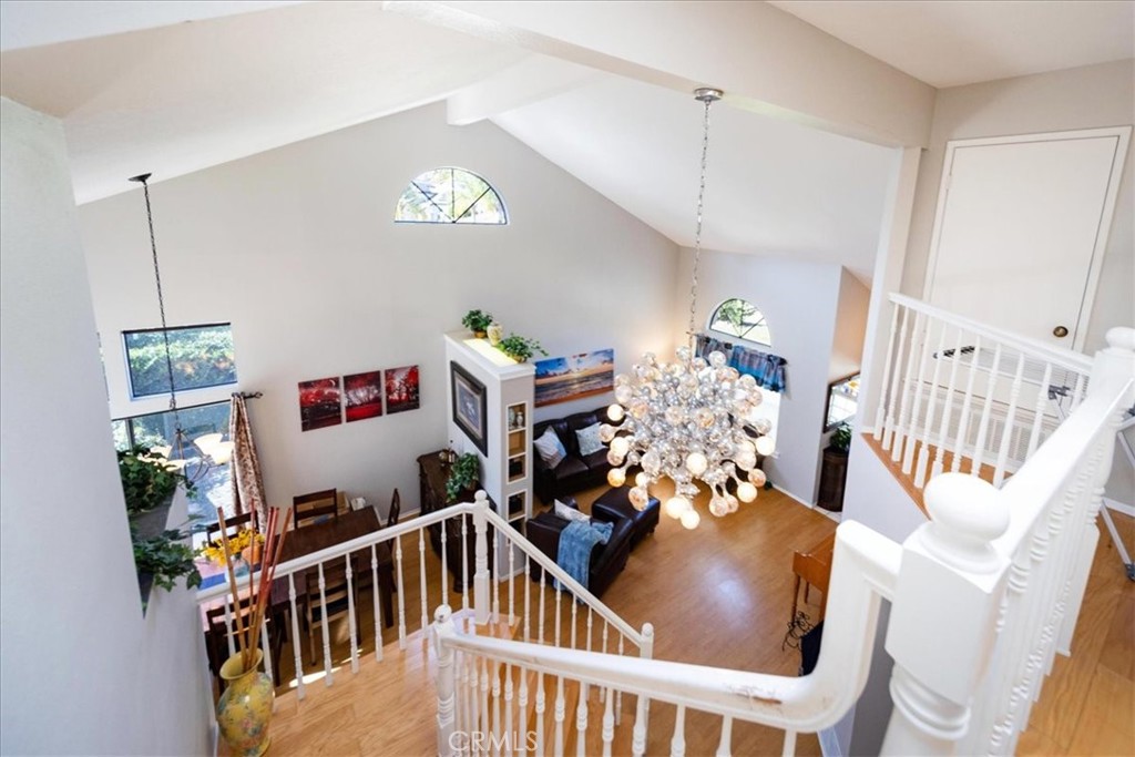 5963 Rio Valle Drive Bonsall, CA 92003 - Photo 20 of 49 a room with furniture a baby crib and a wooden floor