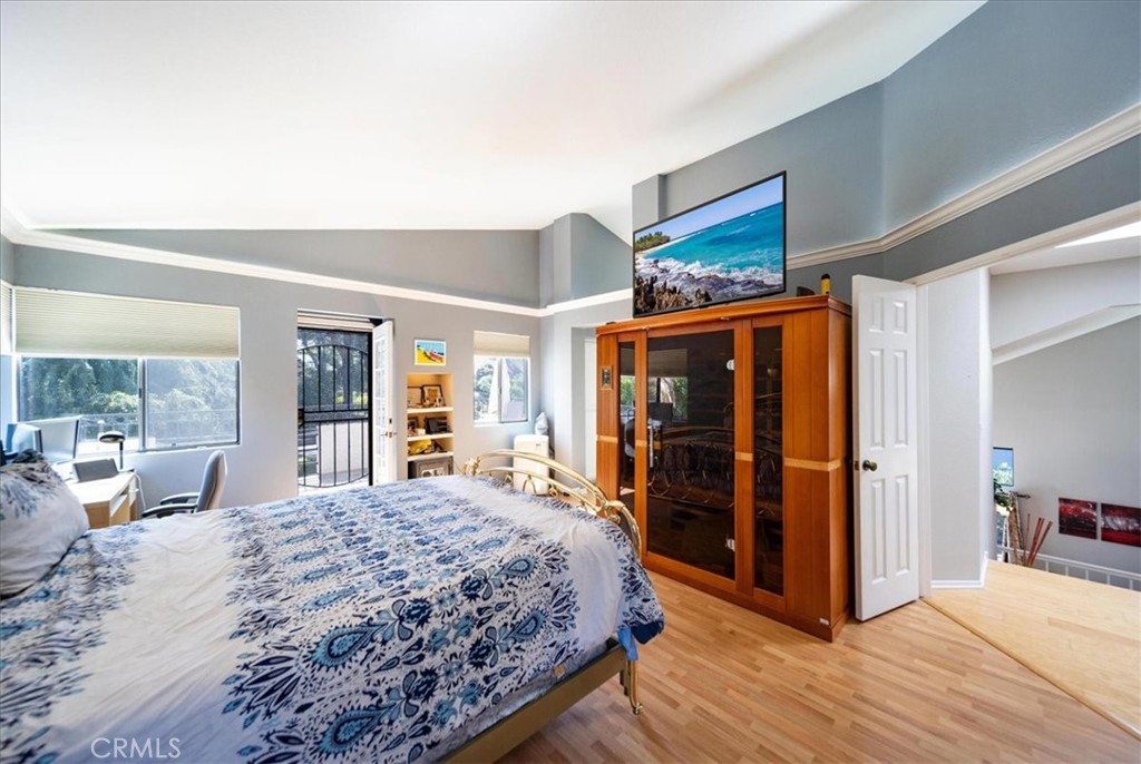 5963 Rio Valle Drive Bonsall, CA 92003 - Photo 21 of 49 a bedroom with a large bed a flat tv screen and dresser