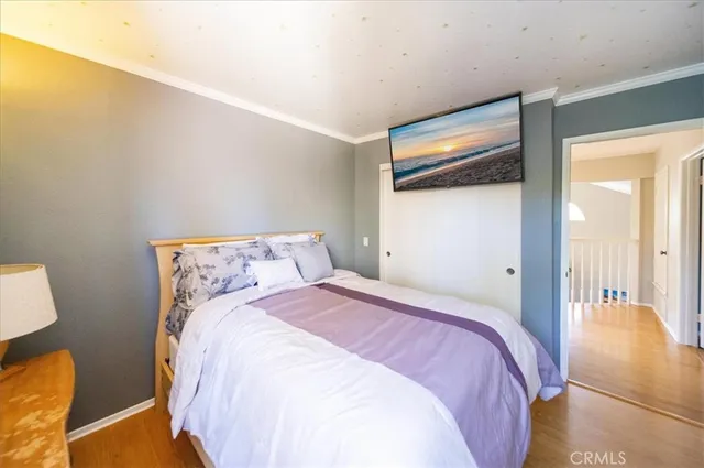 a bedroom with a bed and a large mirror