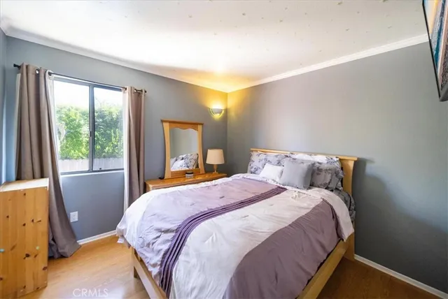 a bed sitting in a bedroom next to a window