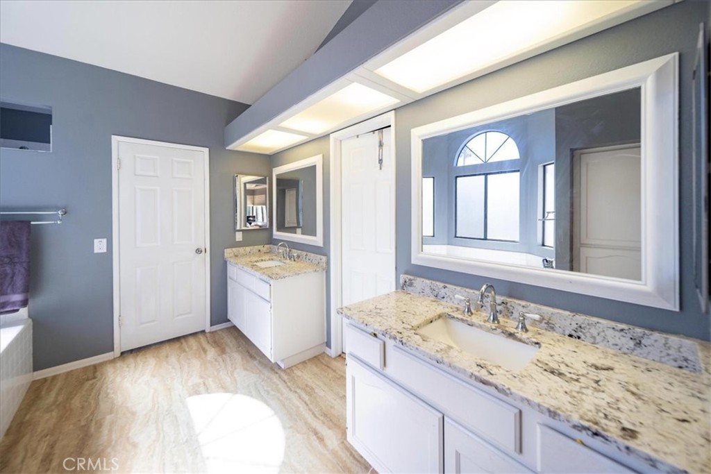 5963 Rio Valle Drive Bonsall, CA 92003 - Photo 33 of 49 a bathroom with a granite countertop sink and mirror with bathtub