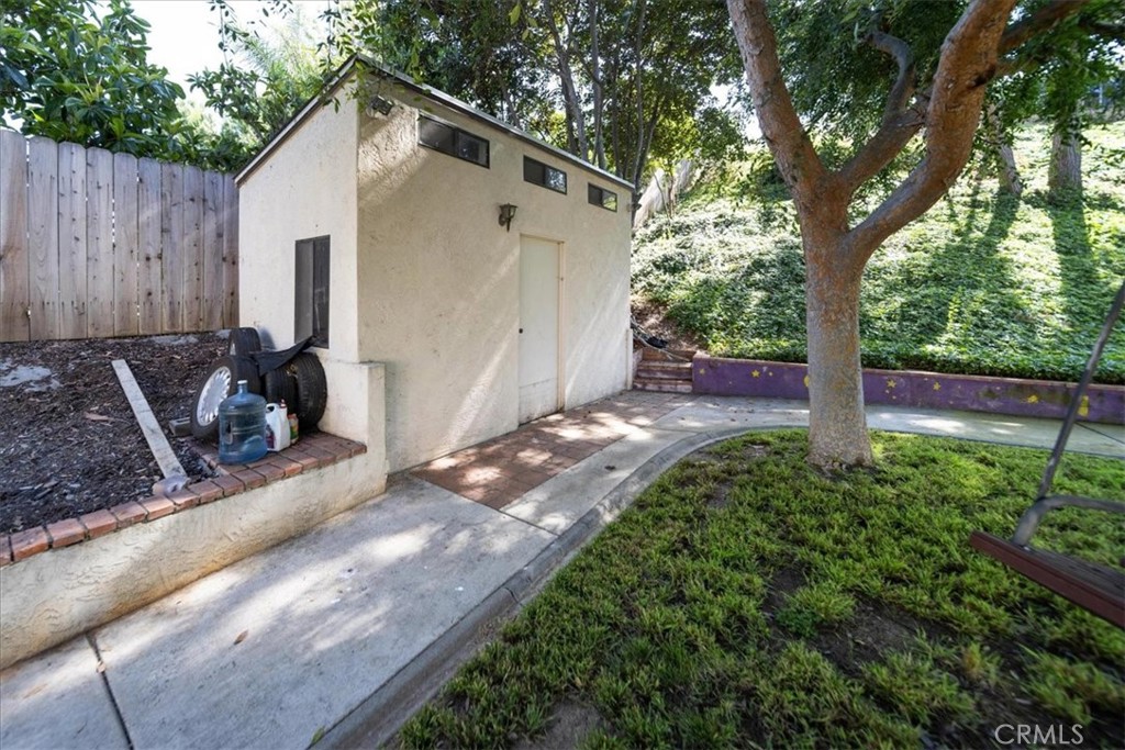 5963 Rio Valle Drive Bonsall, CA 92003 - Photo 45 of 49 a view of backyard with large trees and wooden fence