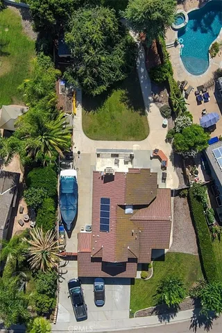 an aerial view of a house with garden space and street view