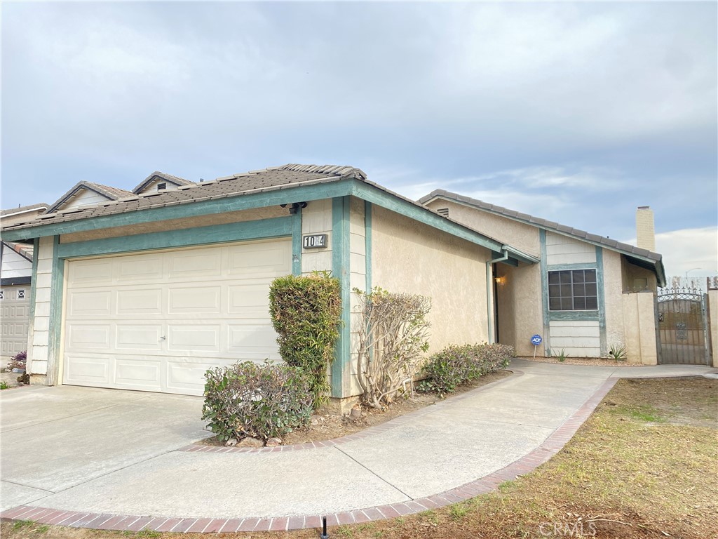 1084 North Jacaranda Road Colton, CA 92324 - Photo 1 of 19 a front view of a house with garden