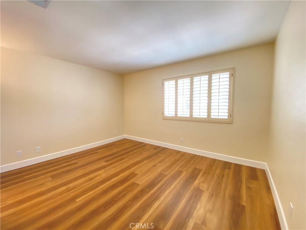 1084 North Jacaranda Road Colton, CA 92324 - Photo 11 of 19 an empty room with wooden floor and windows