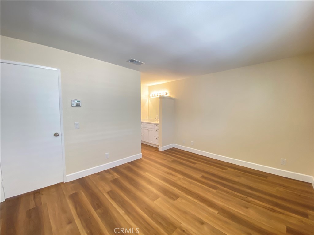 1084 North Jacaranda Road Colton, CA 92324 - Photo 12 of 19 a view of an empty room with wooden floor and a window