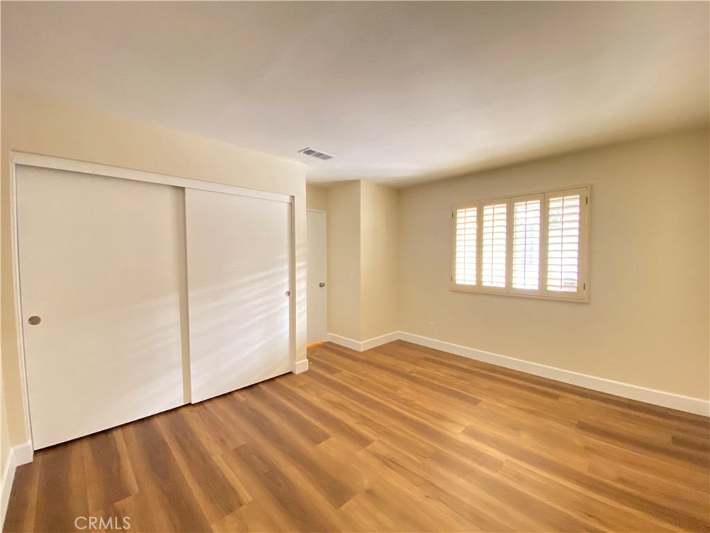 1084 North Jacaranda Road Colton, CA 92324 - Photo 14 of 19 a view of an empty room with wooden floor and a window