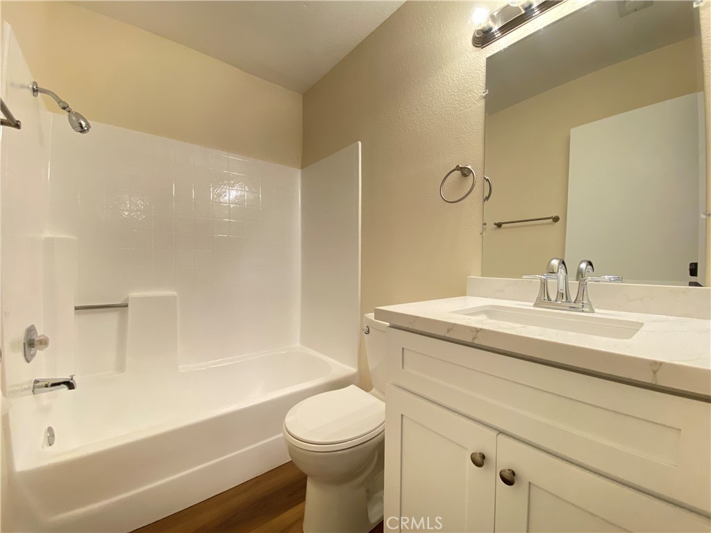1084 North Jacaranda Road Colton, CA 92324 - Photo 16 of 19 a bathroom with a granite countertop sink toilet and shower