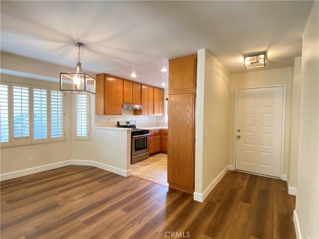 1084 North Jacaranda Road Colton, CA 92324 - Photo 2 of 19 a open kitchen with a refrigerator stove top oven and cabinets