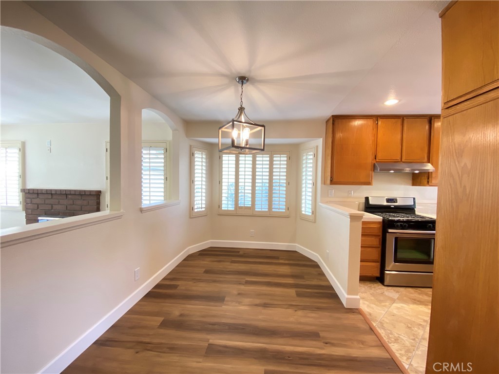 1084 North Jacaranda Road Colton, CA 92324 - Photo 4 of 19 a view of a kitchen with a sink wooden floor and a window