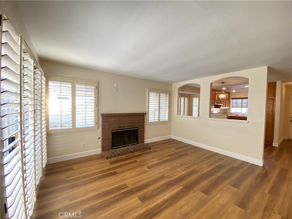 1084 North Jacaranda Road Colton, CA 92324 - Photo 7 of 19 a view of empty room with wooden floor and fireplace