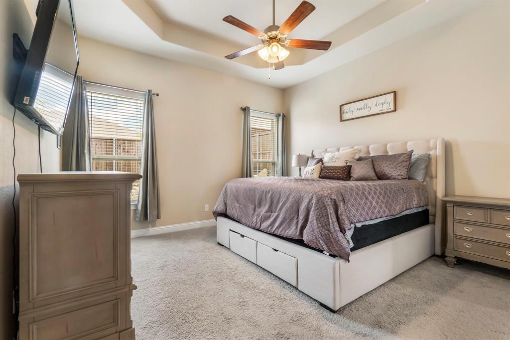3610 Bastrop Street Melissa, TX 75454 - Photo 14 of 23 a bedroom with a large bed and a chandelier