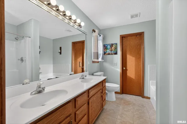 a bathroom with a sink double vanity and a mirror