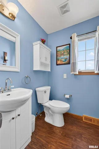 a bathroom with a toilet sink and mirror