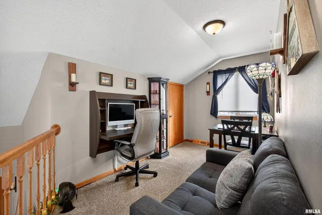 a livingroom with workspace and a couch