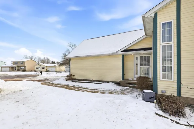 a view of a house with snow on the road