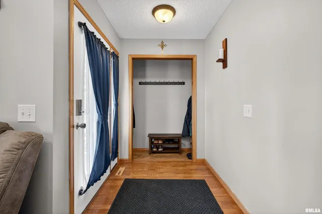 a view of a hallway with furniture and a window
