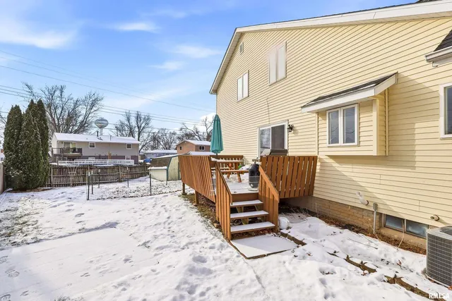 a view of a terrace with chairs and wooden fence