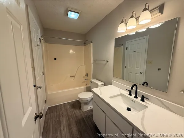 a bathroom with a double vanity sink mirror double and bathtub