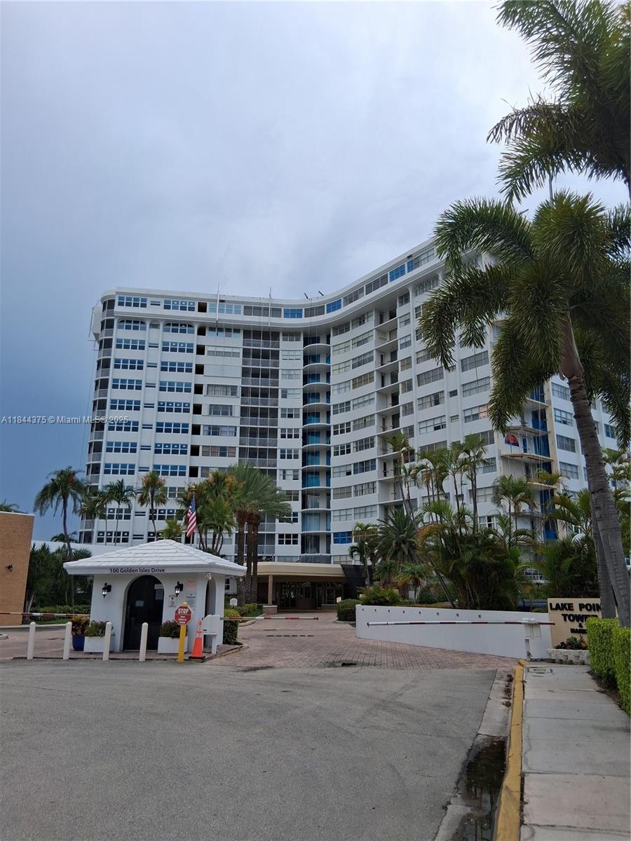 100 Golden Isles Drive, Unit 206 Hallandale Beach, FL 33009 - Photo 1 of 22 a front view of a building with streets and trees