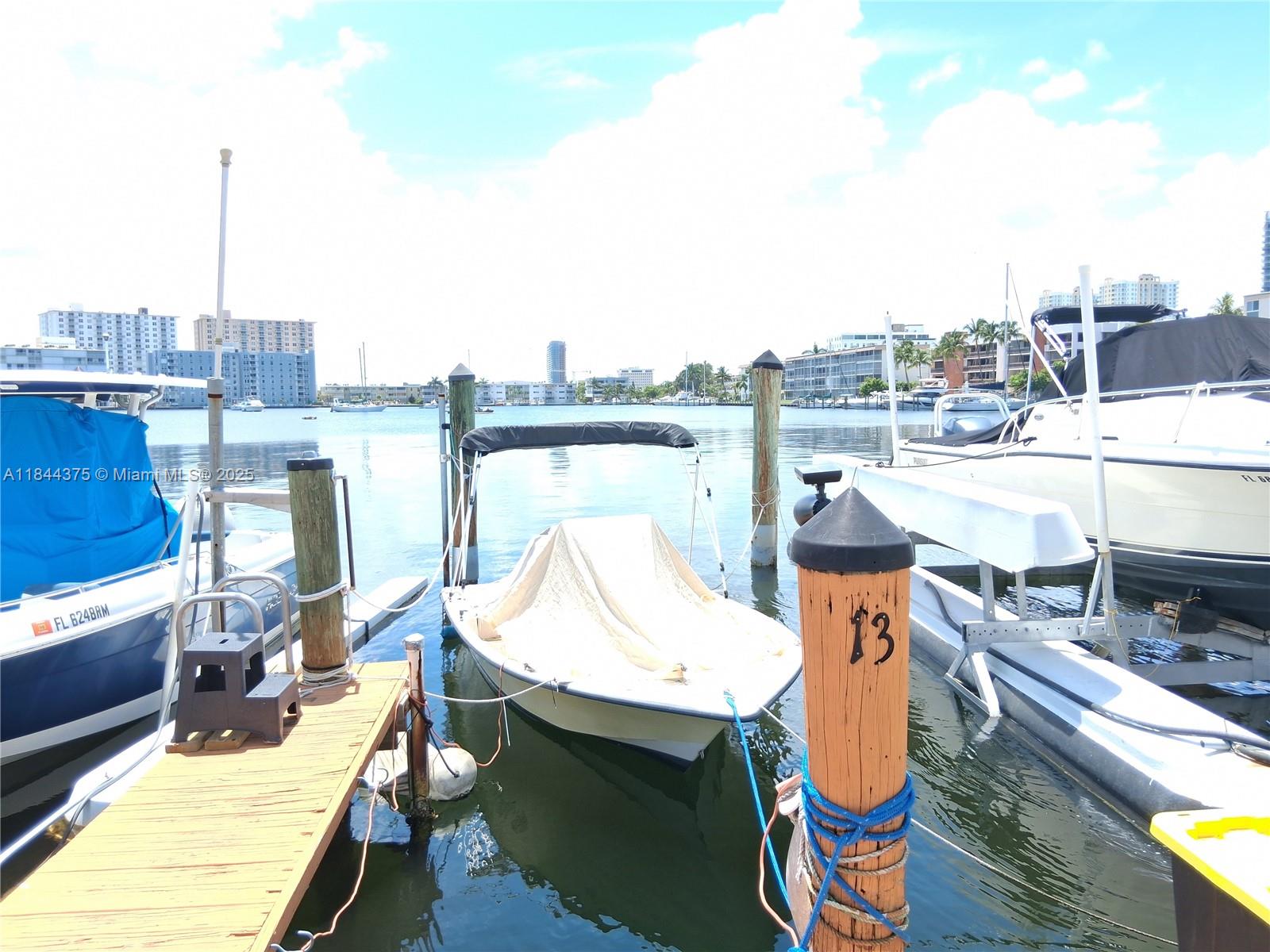 100 Golden Isles Drive, Unit 206 Hallandale Beach, FL 33009 - Photo 14 of 22 a view of a balcony with two chairs and a table