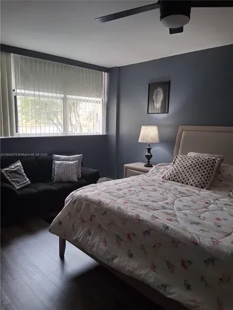 a bedroom with bed and window