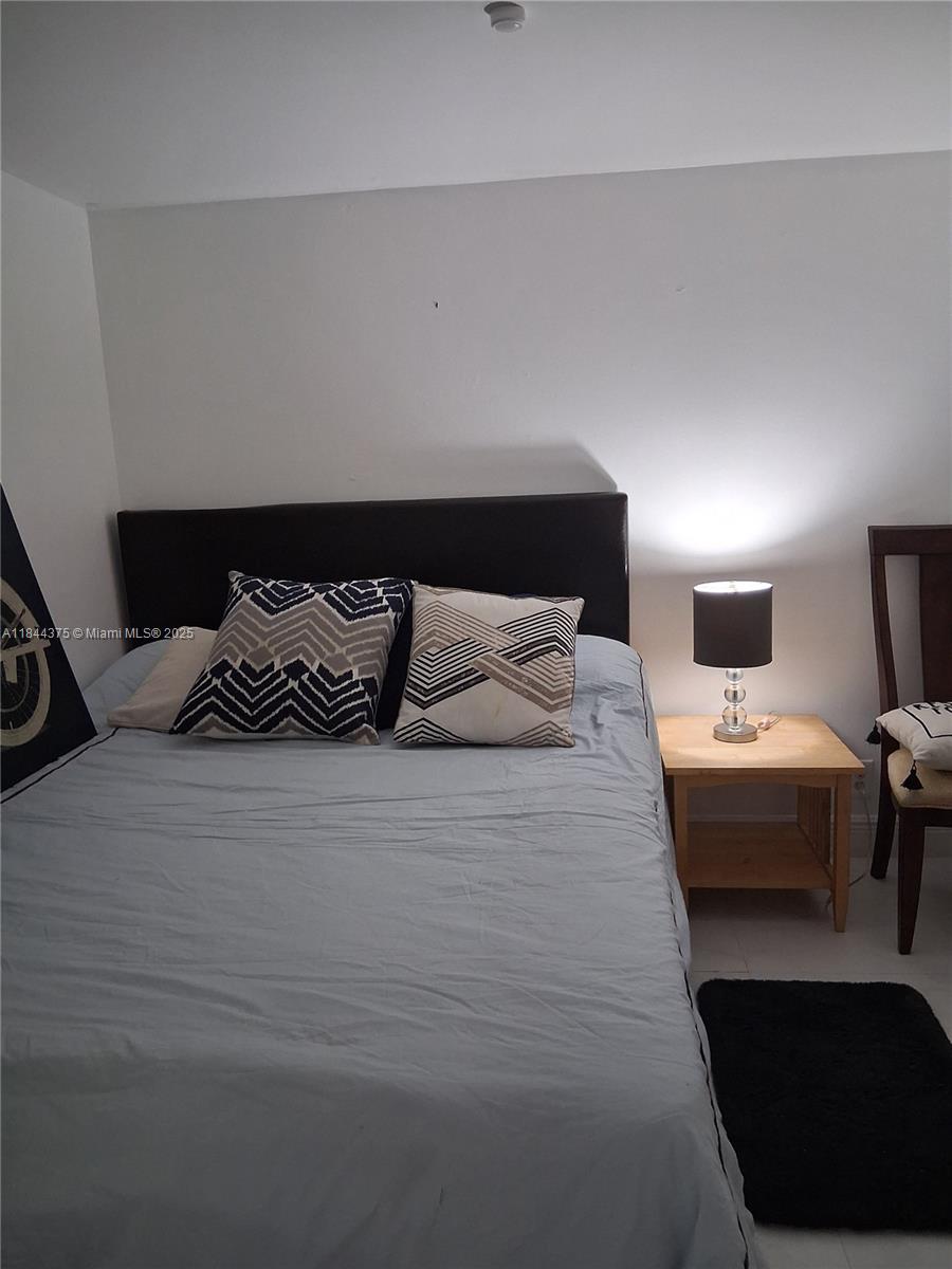 100 Golden Isles Drive, Unit 206 Hallandale Beach, FL 33009 - Photo 21 of 22 a bedroom with bed and window