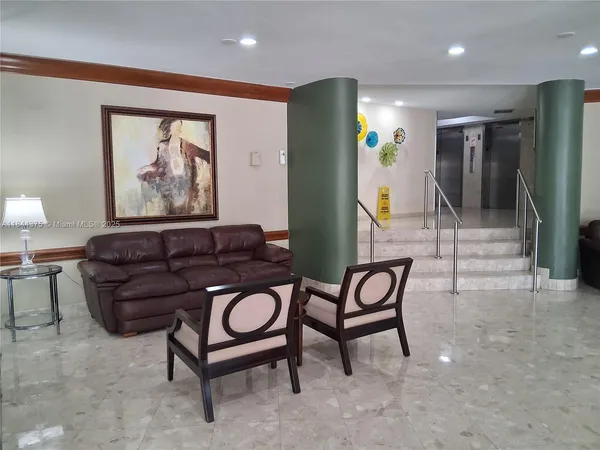 a living room with furniture and a painting on the wall