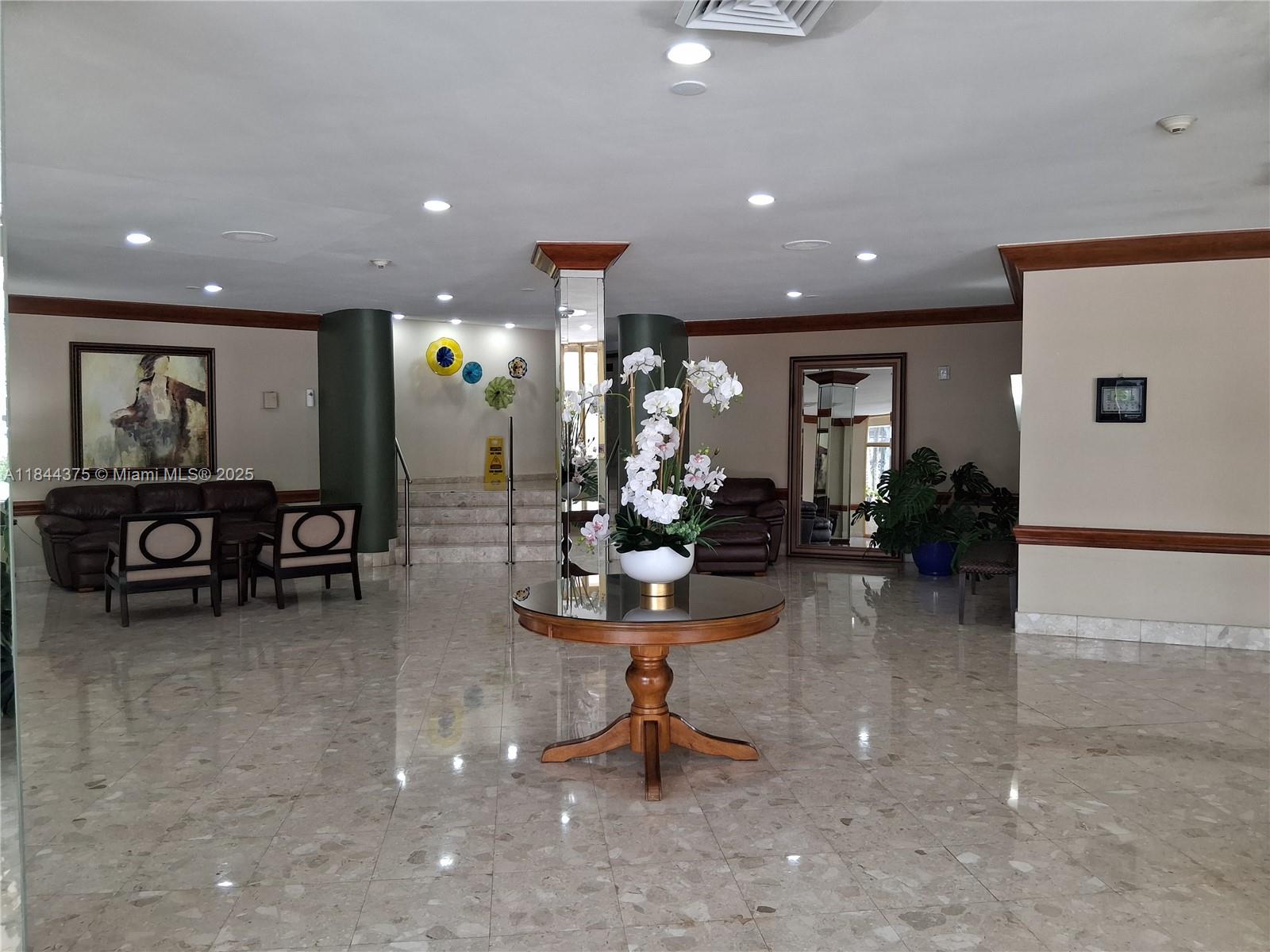 100 Golden Isles Drive, Unit 206 Hallandale Beach, FL 33009 - Photo 6 of 22 a view of a lobby with furniture